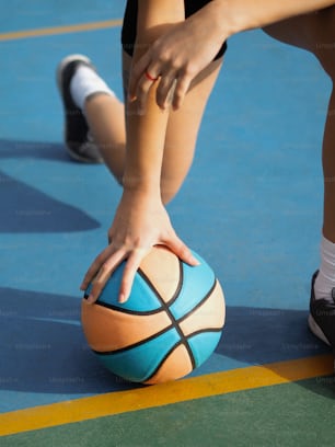 a close up of a person touching a basketball