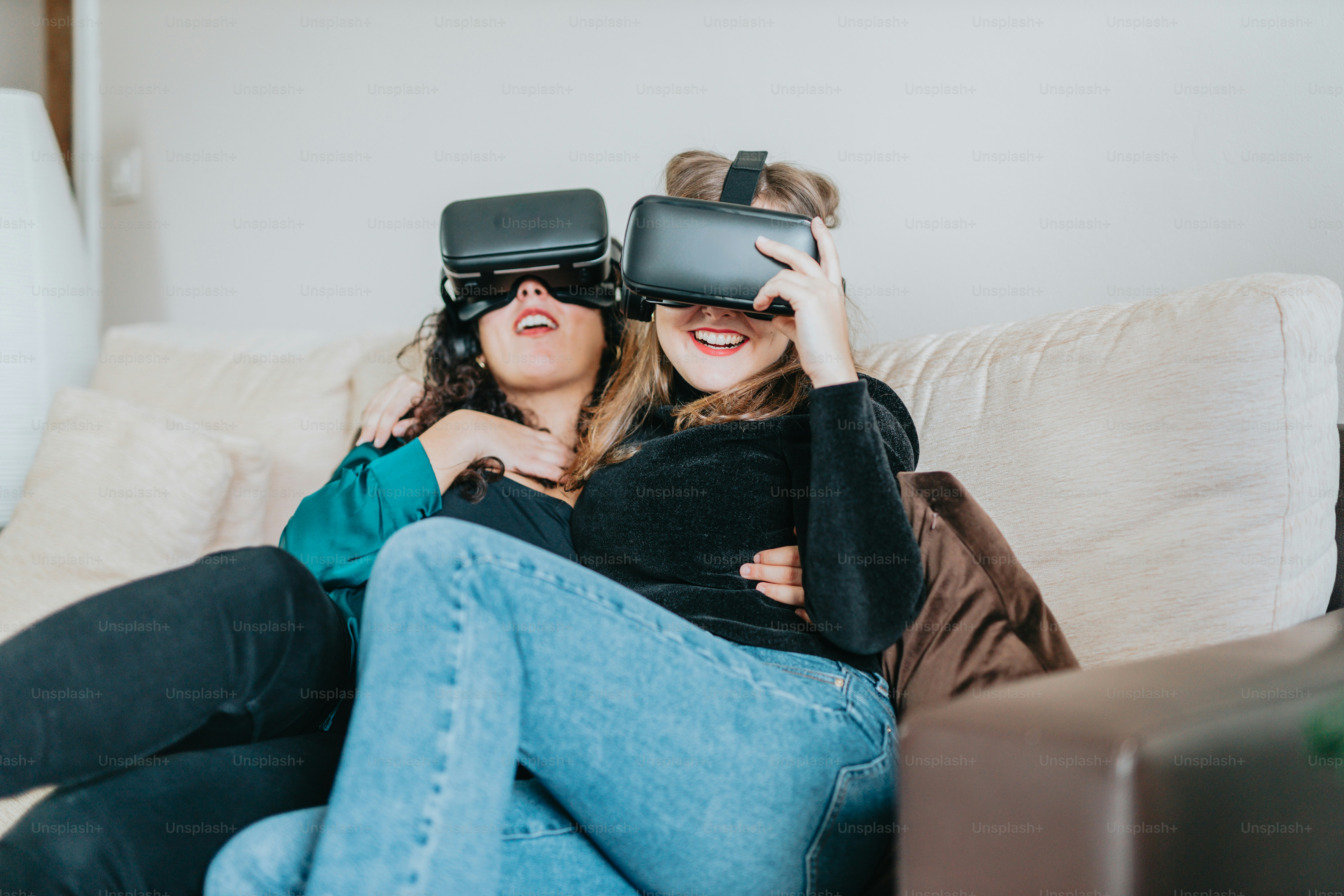 a couple of women sitting on top of a couch
