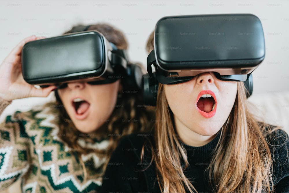 a couple of women wearing virtual glasses on top of their heads