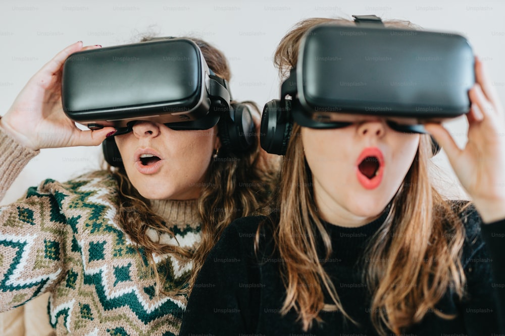 two women wearing virtual headsets look surprised