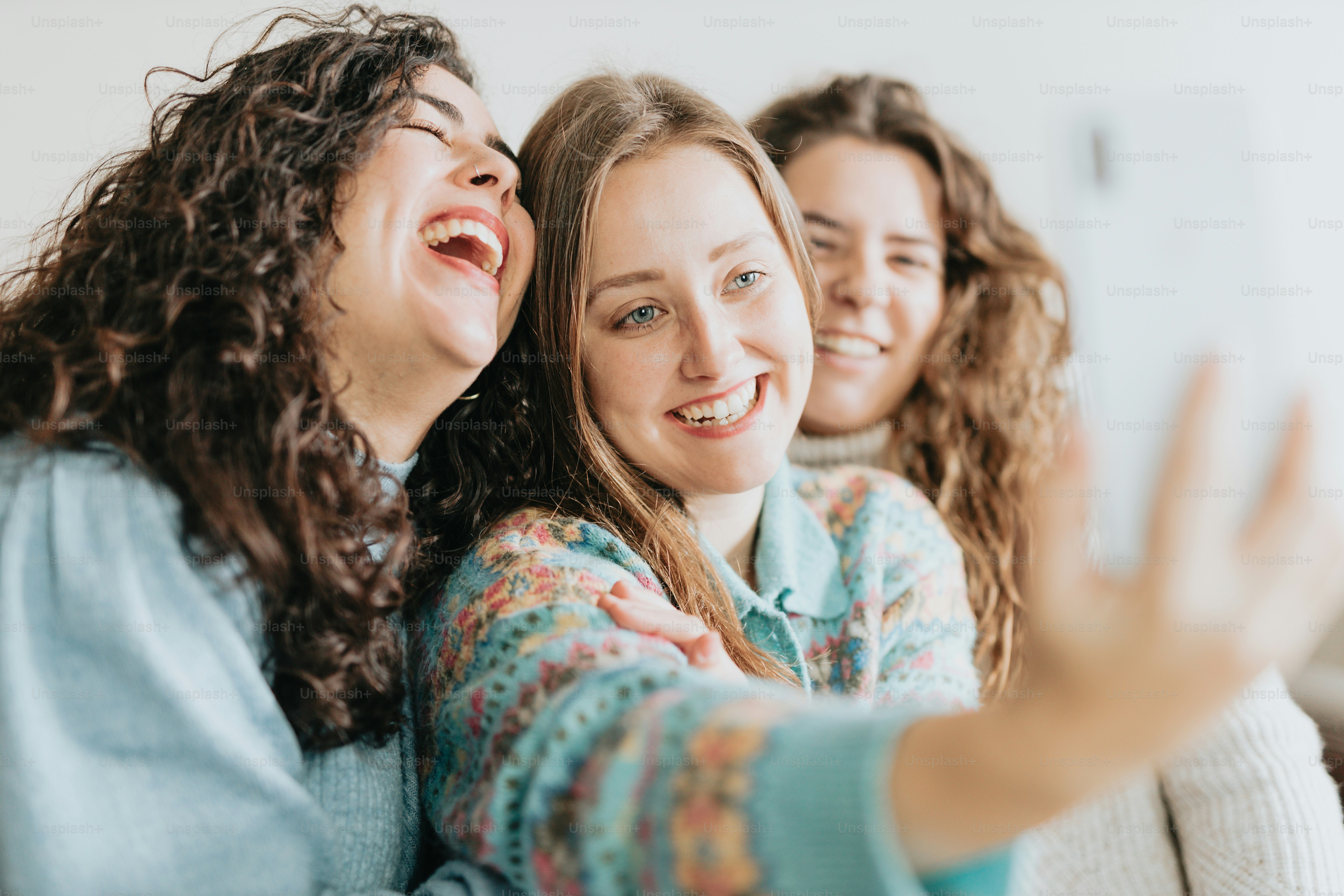 a group of women sitting on top of a couch
