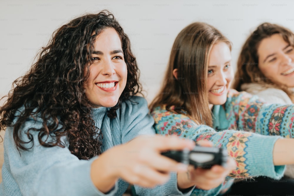 two women sitting on a couch playing a video game