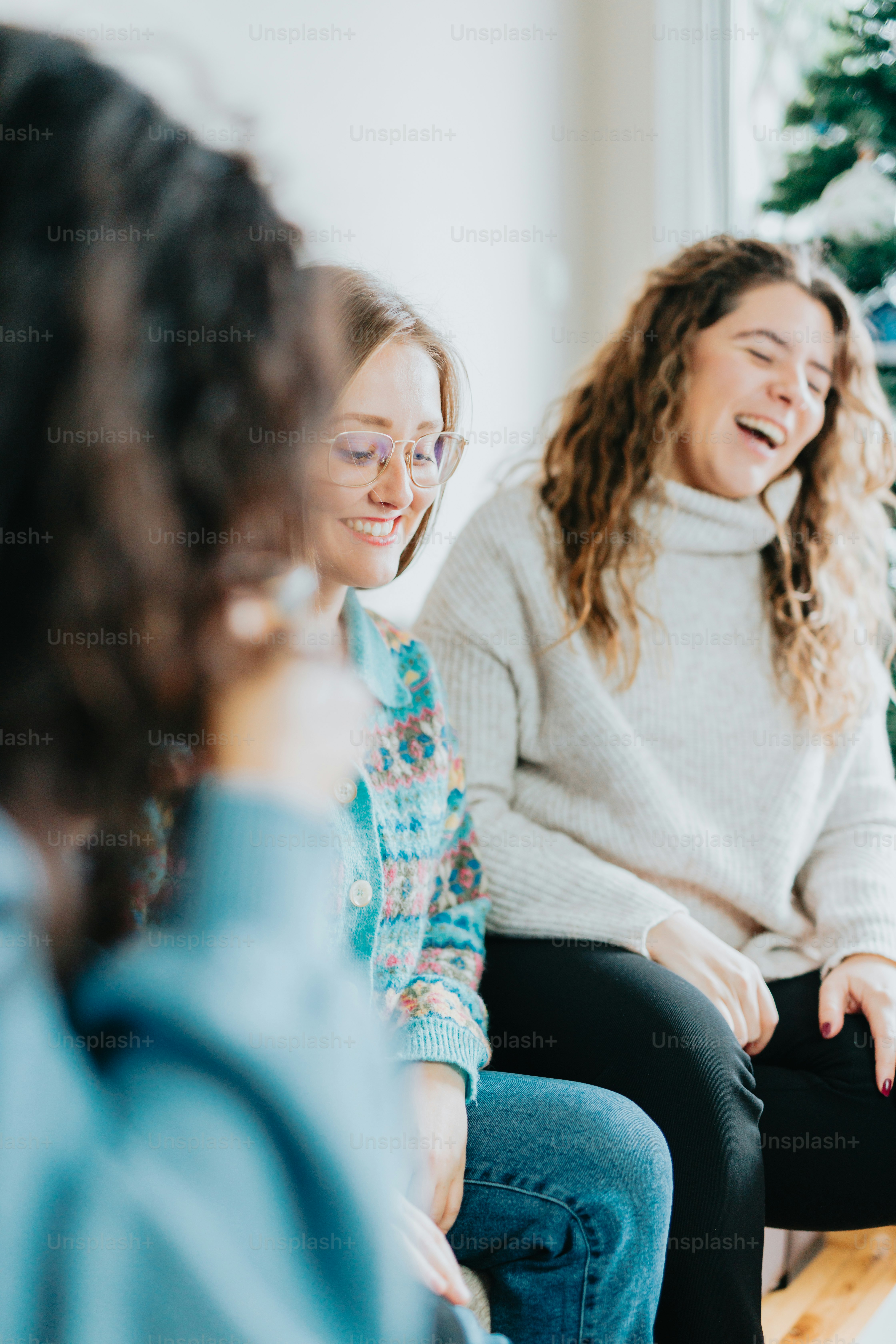 a group of women sitting around each other