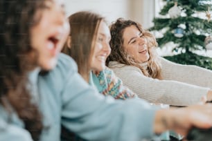 a group of women sitting around a christmas tree
