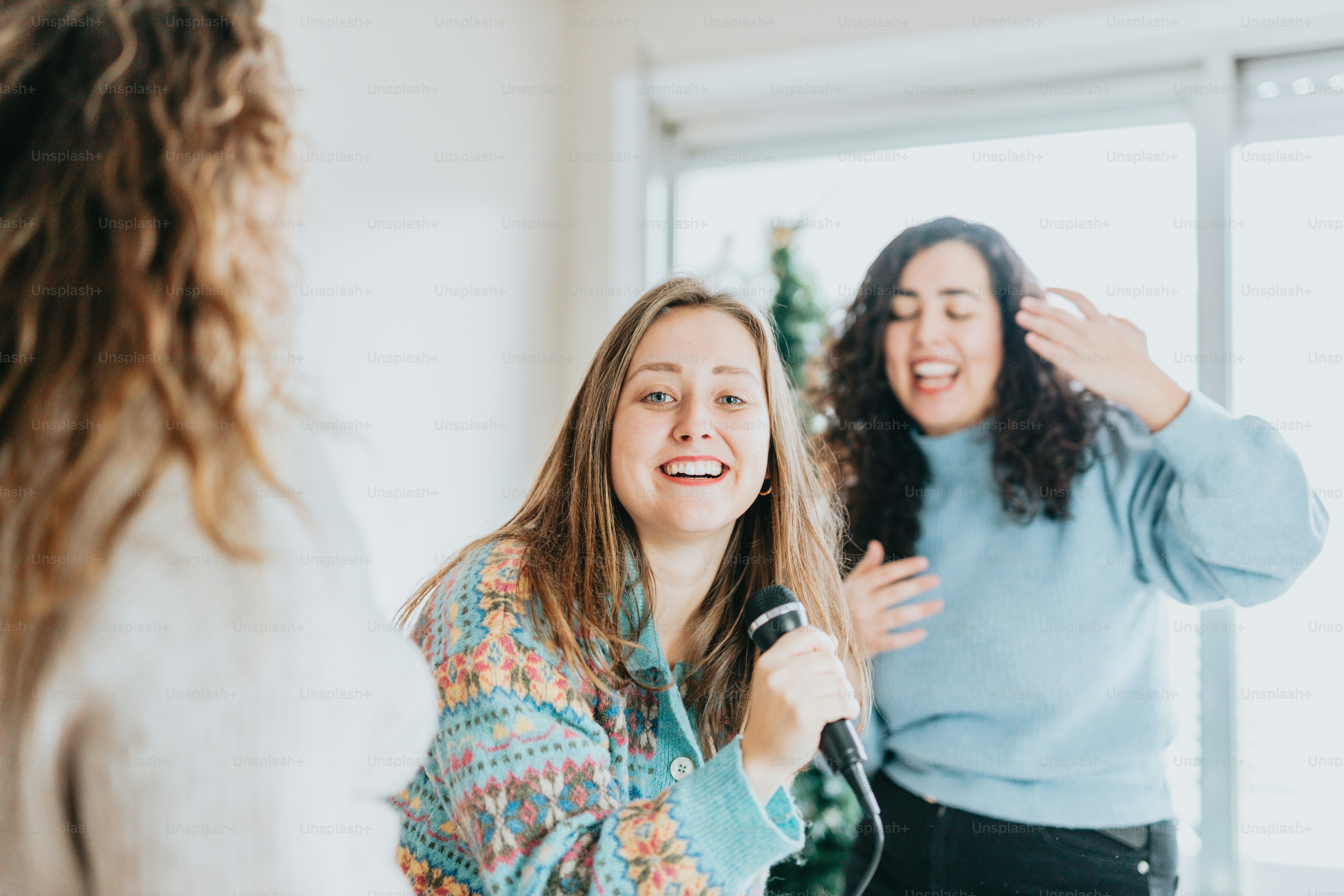 a woman standing in front of a mirror brushing her hair