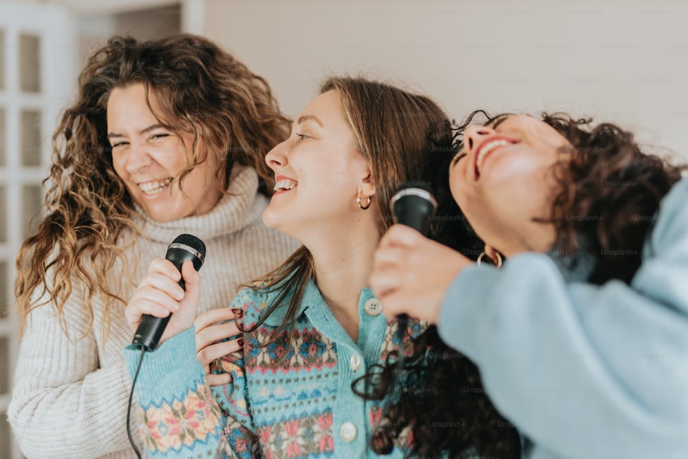 a group of women singing into a microphone