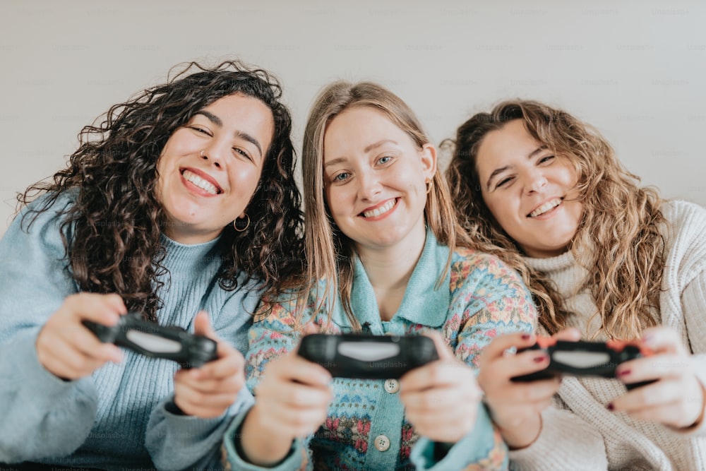 three women are playing a video game together