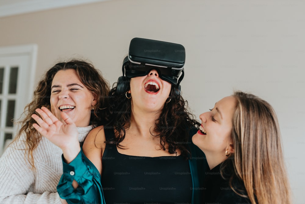 three women laughing while wearing virtual headsets