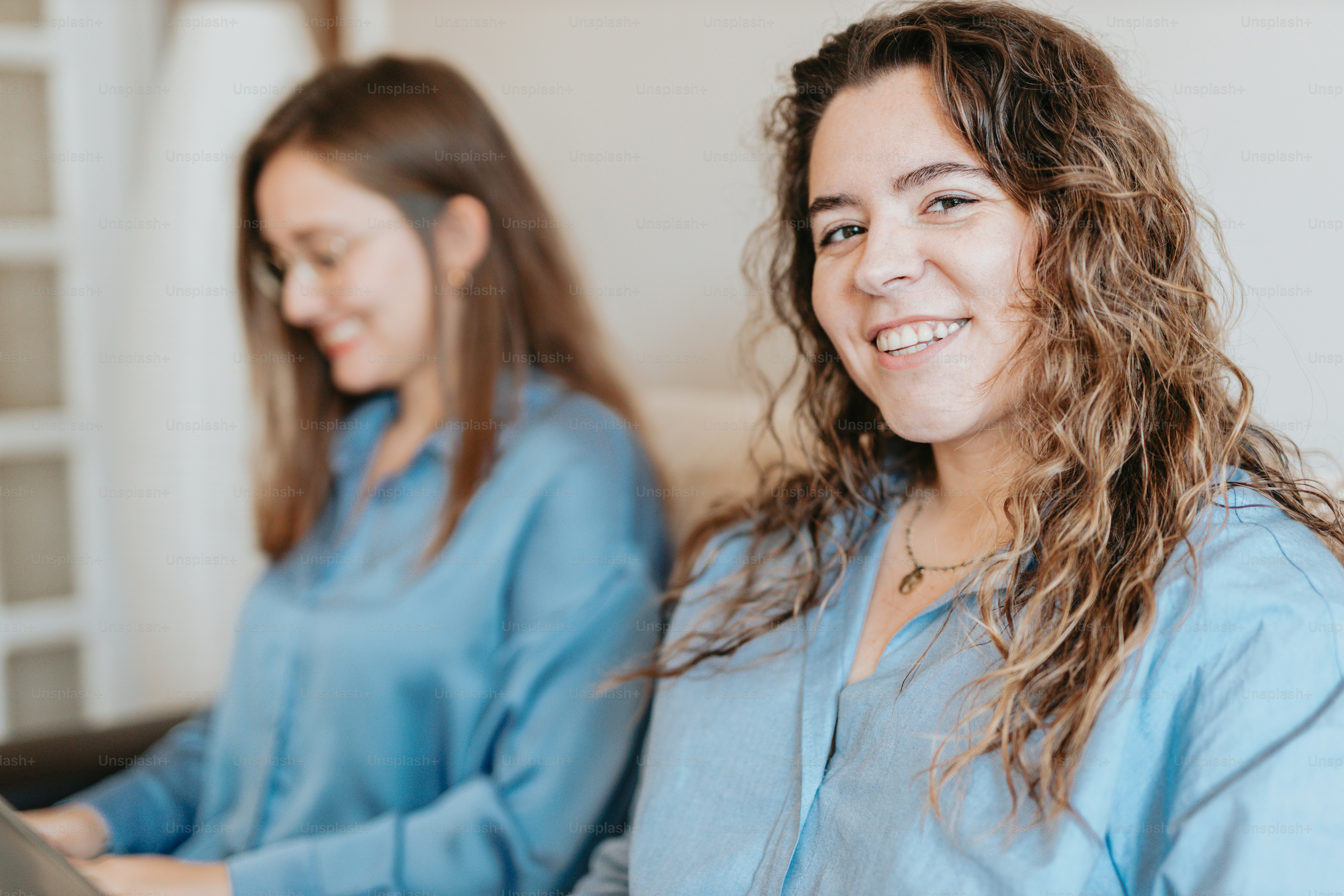 a couple of women sitting next to each other