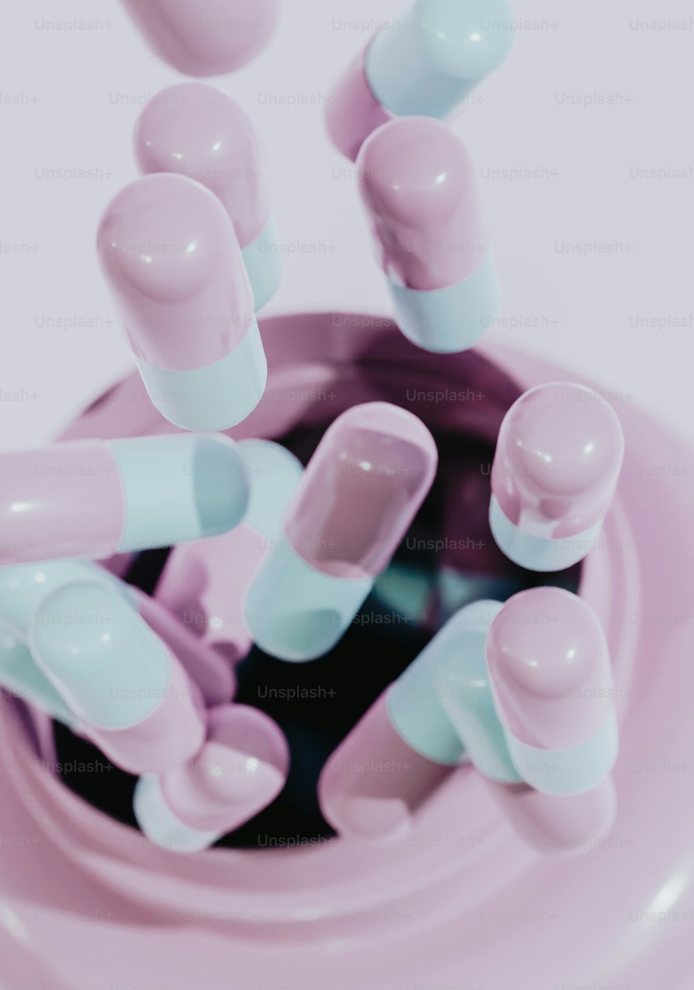 a pink and blue container filled with lots of pills