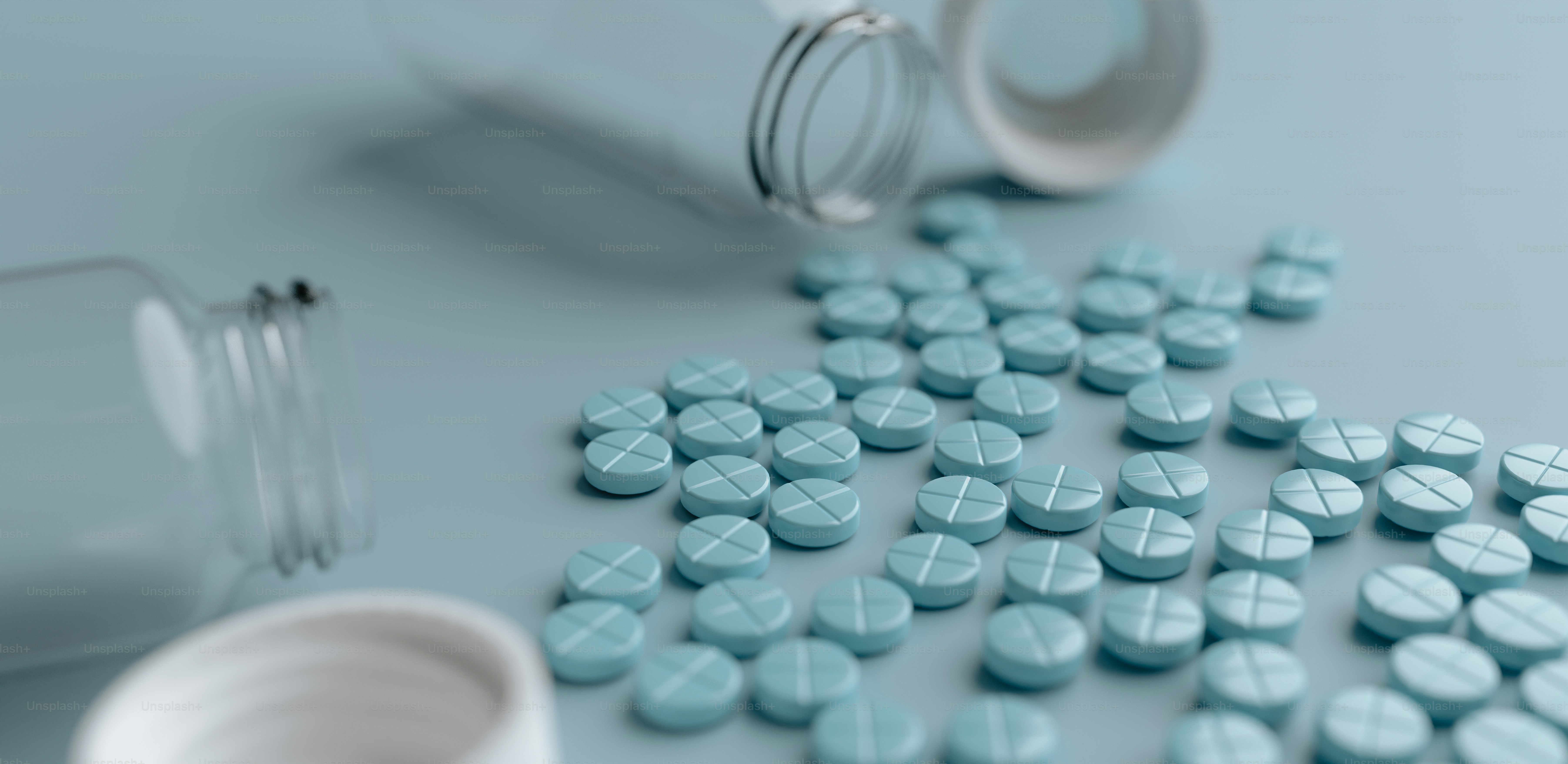 pills spilled out of a bottle onto a table