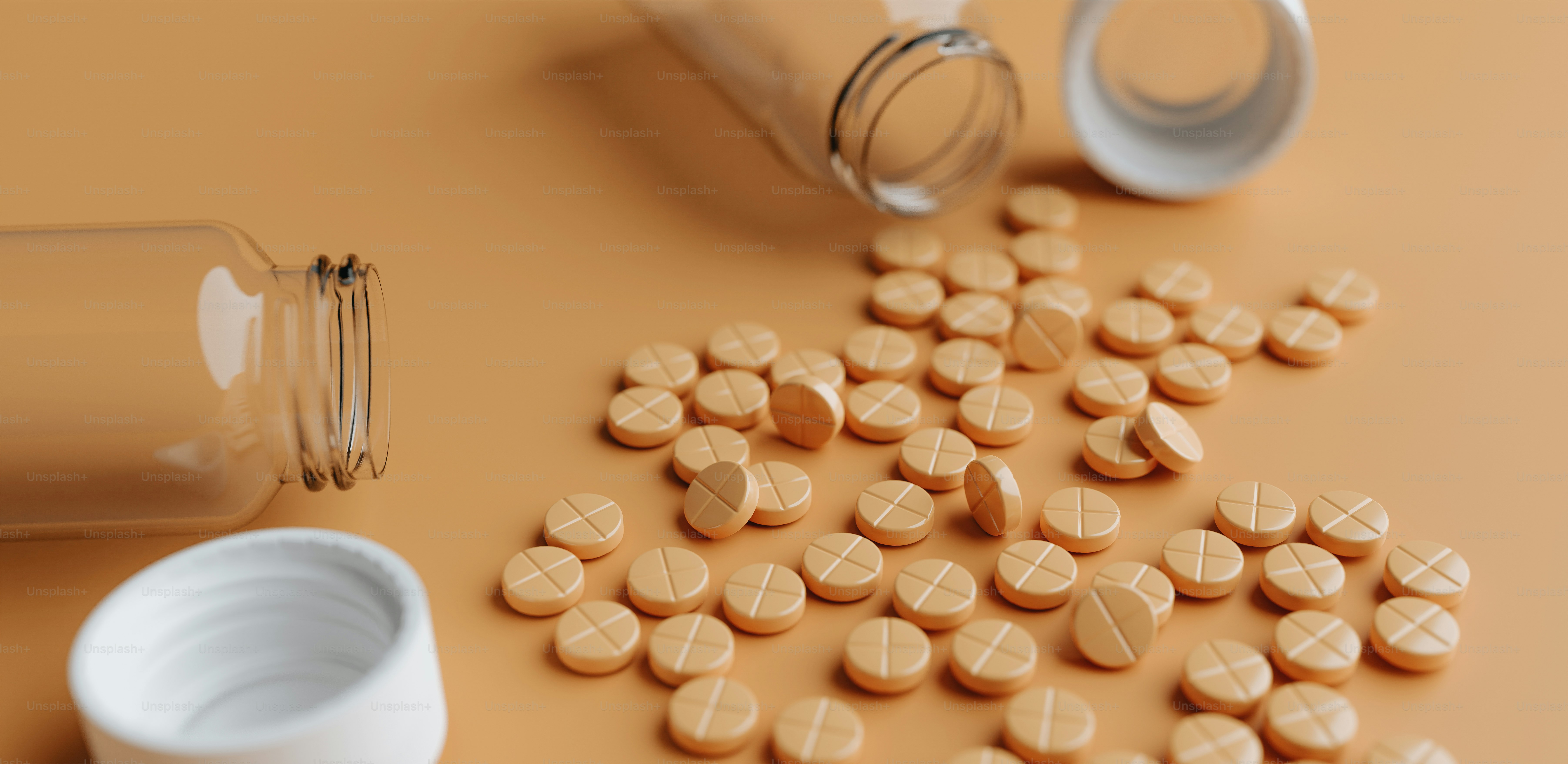 pills spilled out of a bottle onto a table