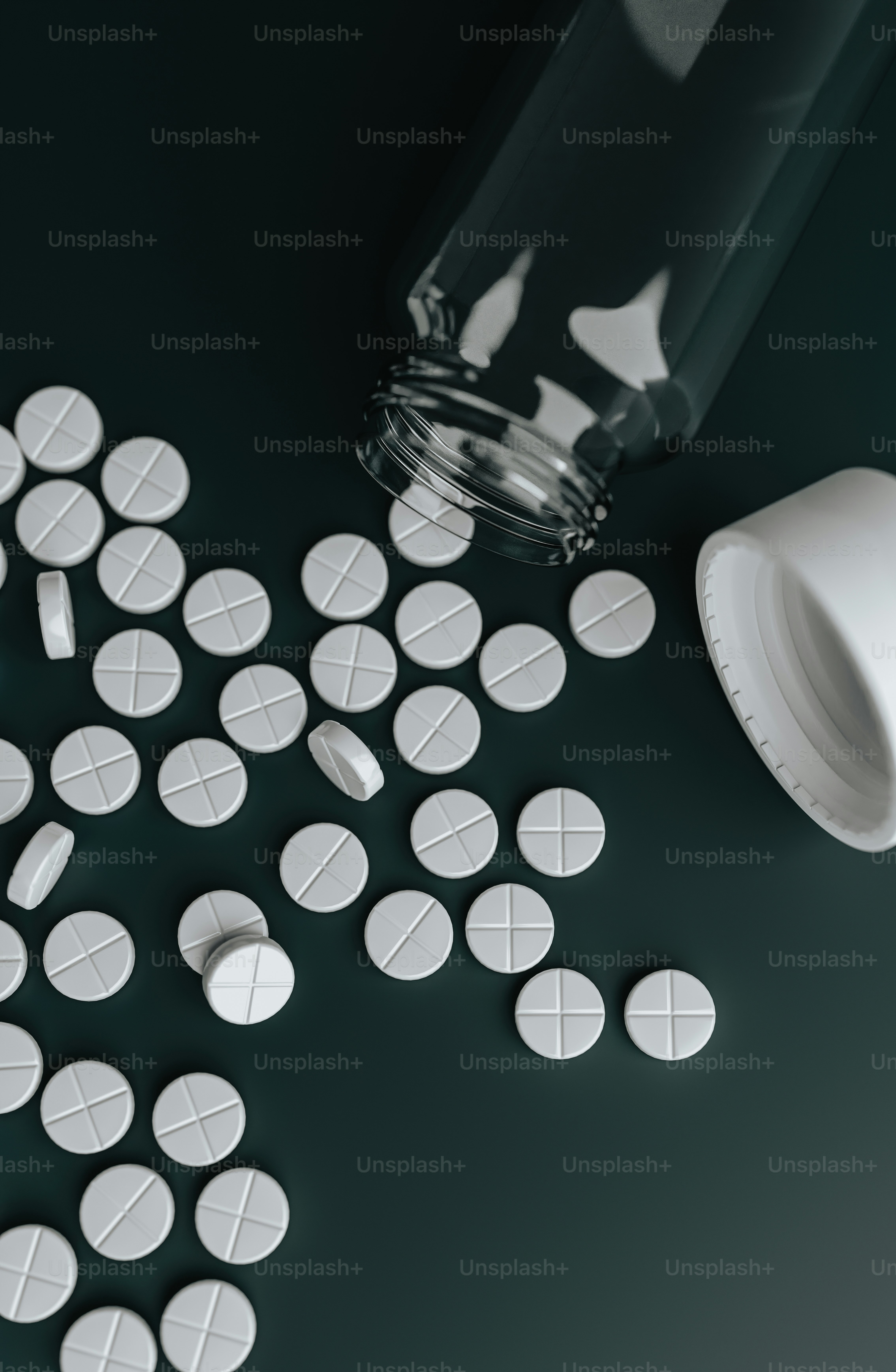 pills spilled out of a bottle onto a table