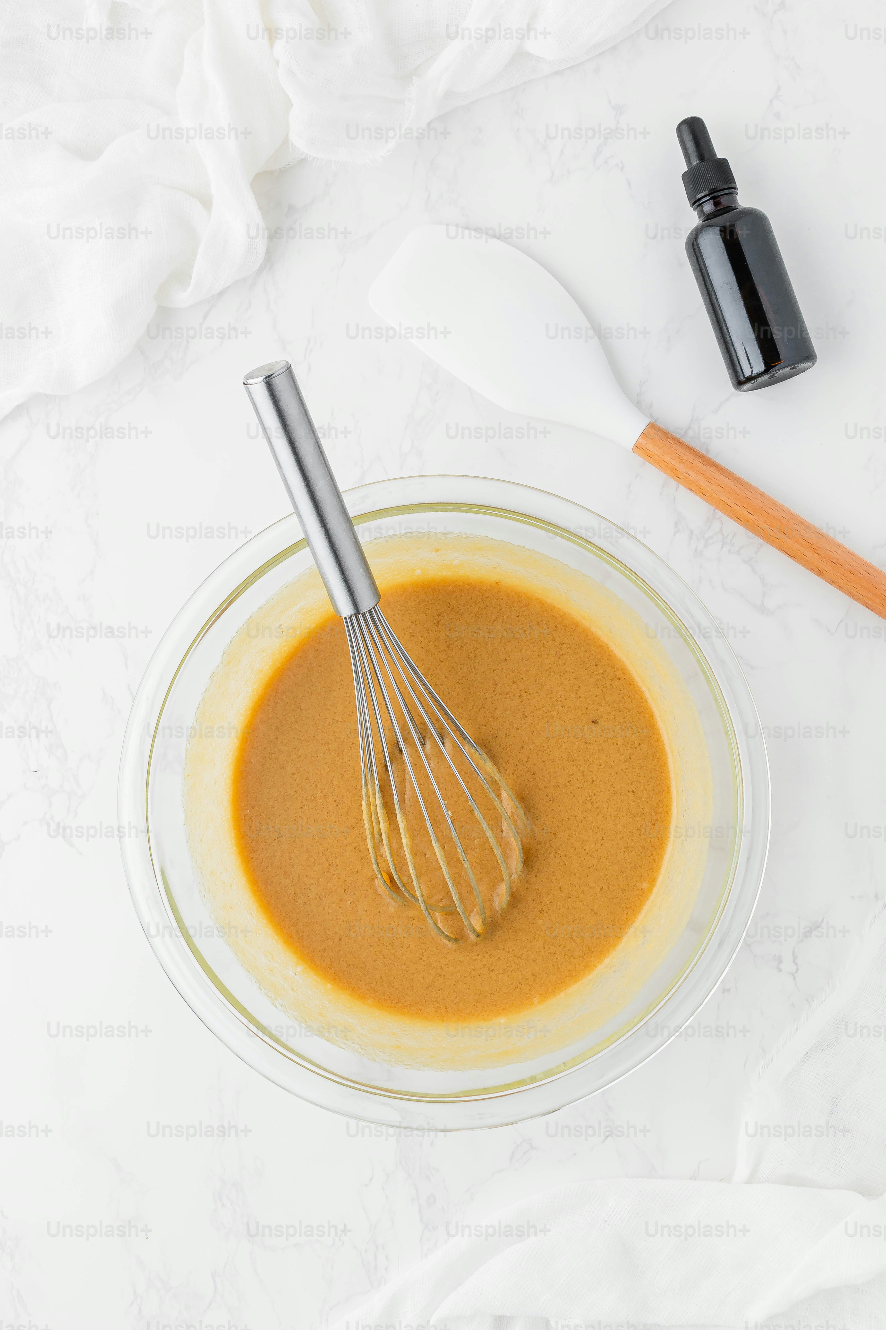 a whisk in a bowl with a liquid in it
