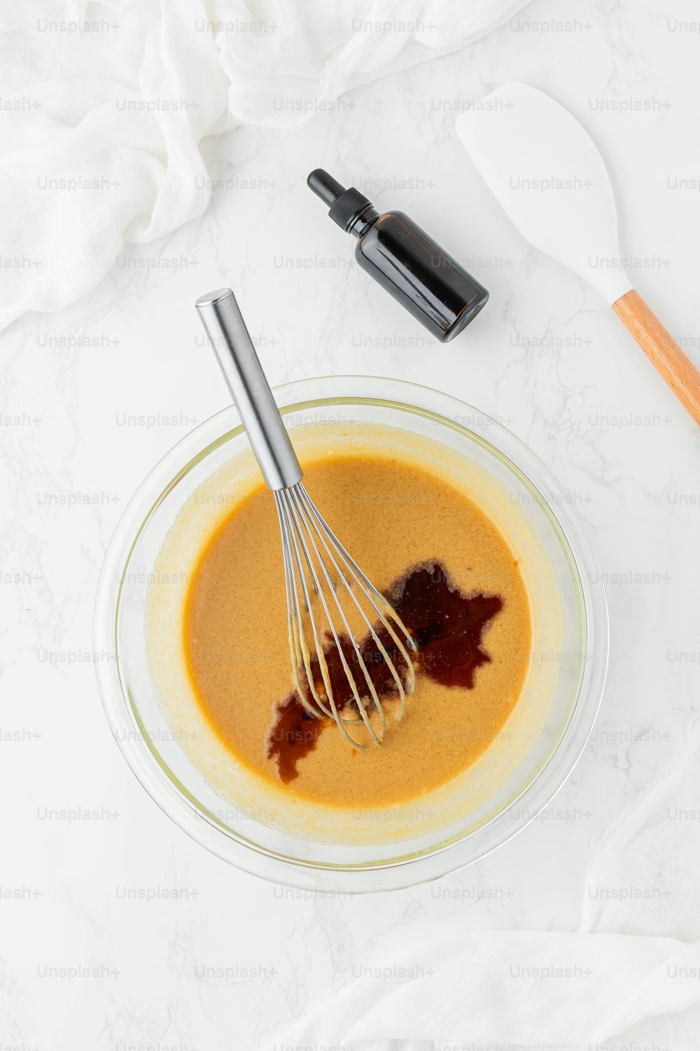 a bowl with a whisk and some sauce in it