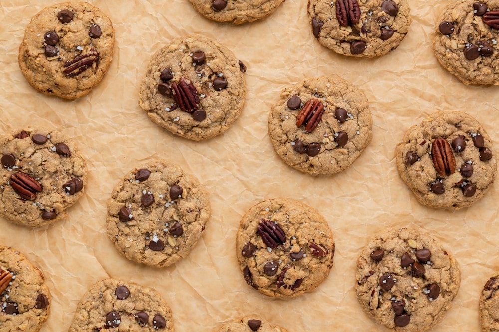 a baking sheet with chocolate chip cookies and pecans