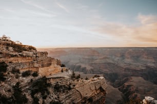 the sun is setting at the edge of the grand canyon