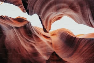 a large rock formation with a sky in the background