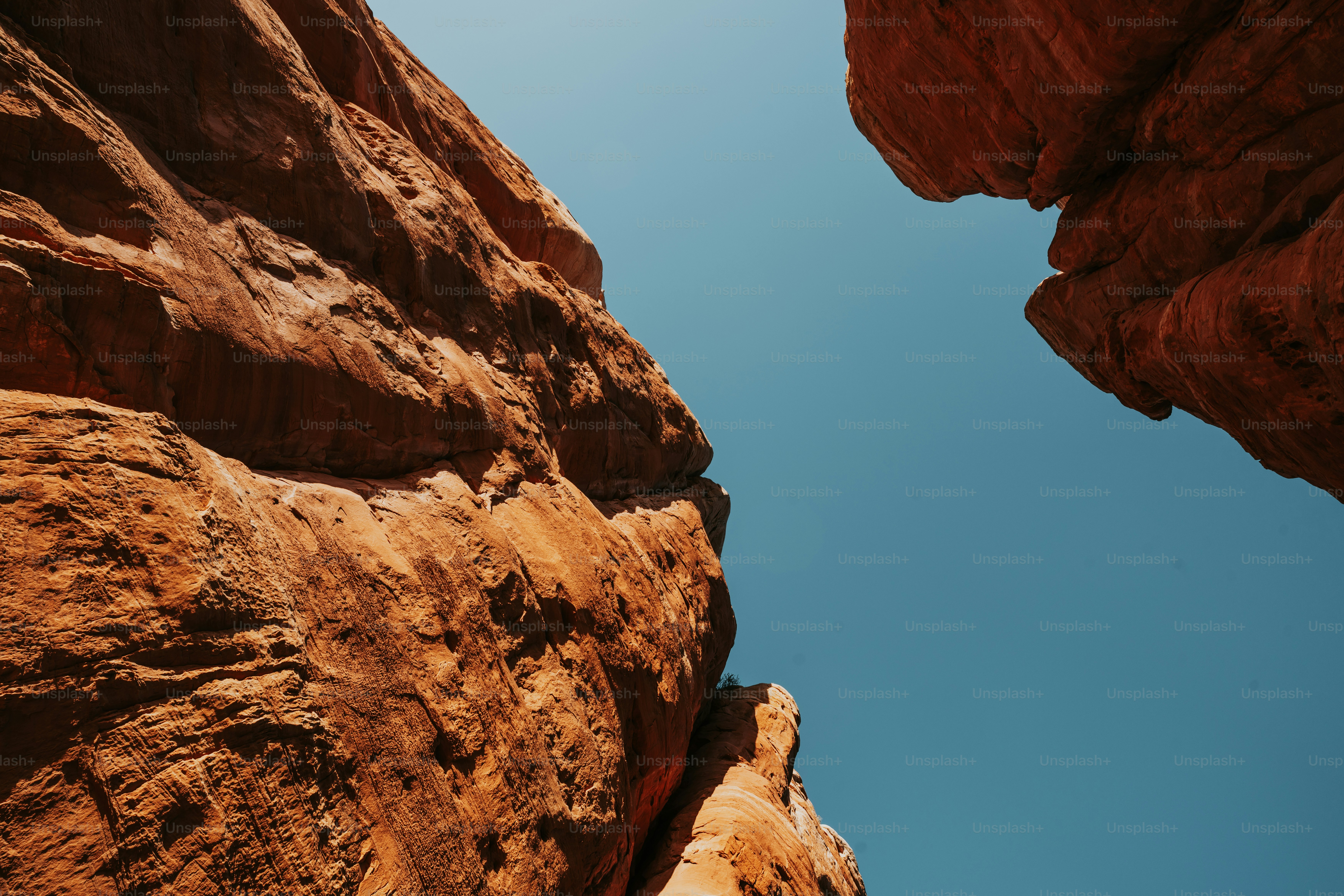 a view looking up at a rock formation