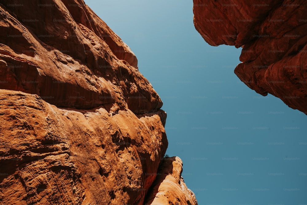 a view looking up at a rock formation