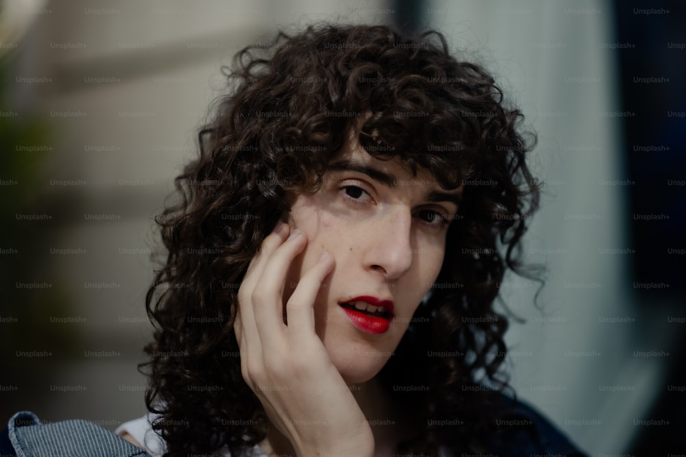 a close up of a person with curly hair