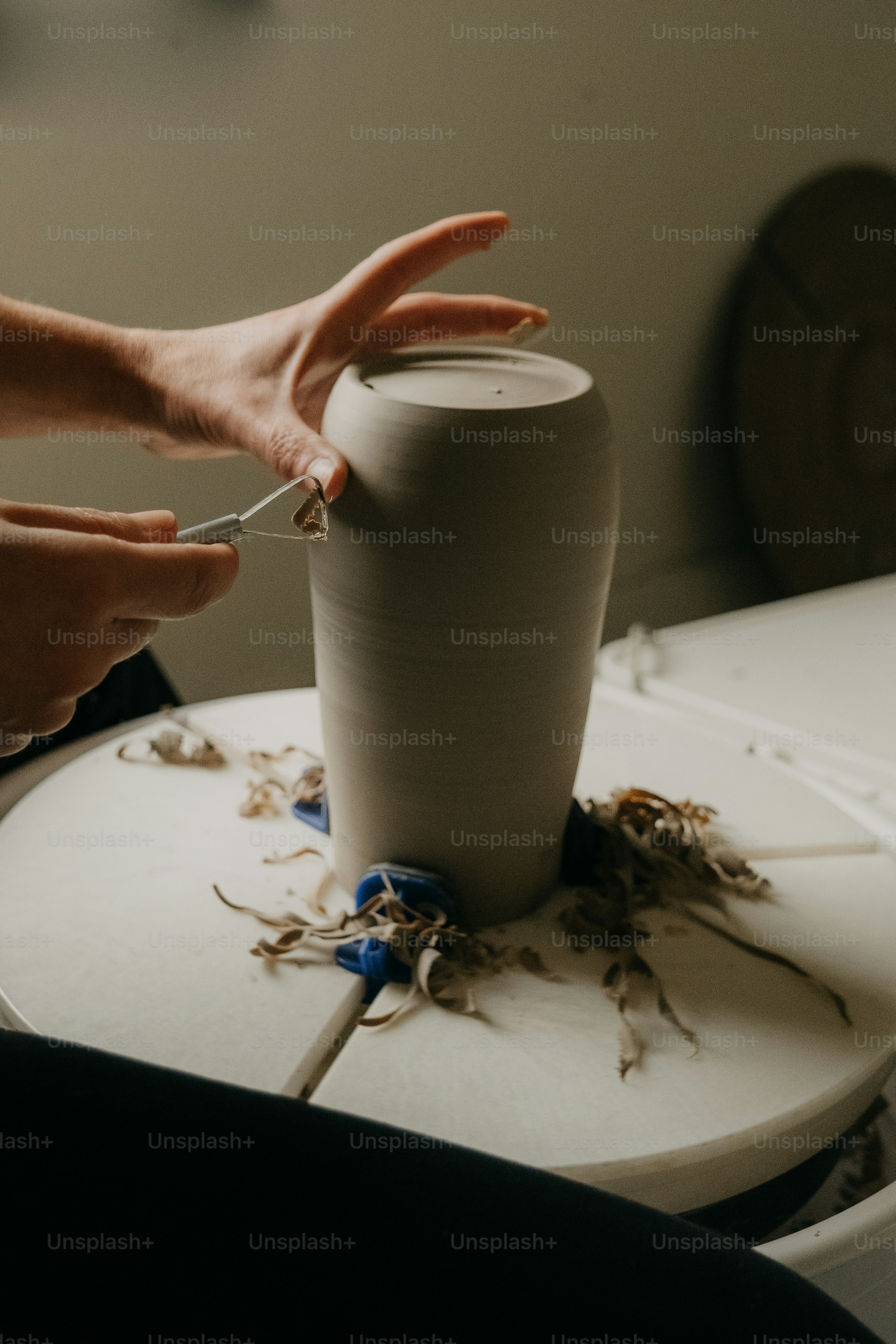 A person is making a vase out of clay photo Pottery Image on Unsplash