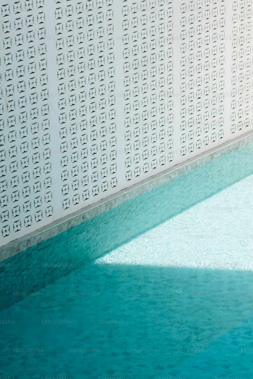 an empty swimming pool with blue water