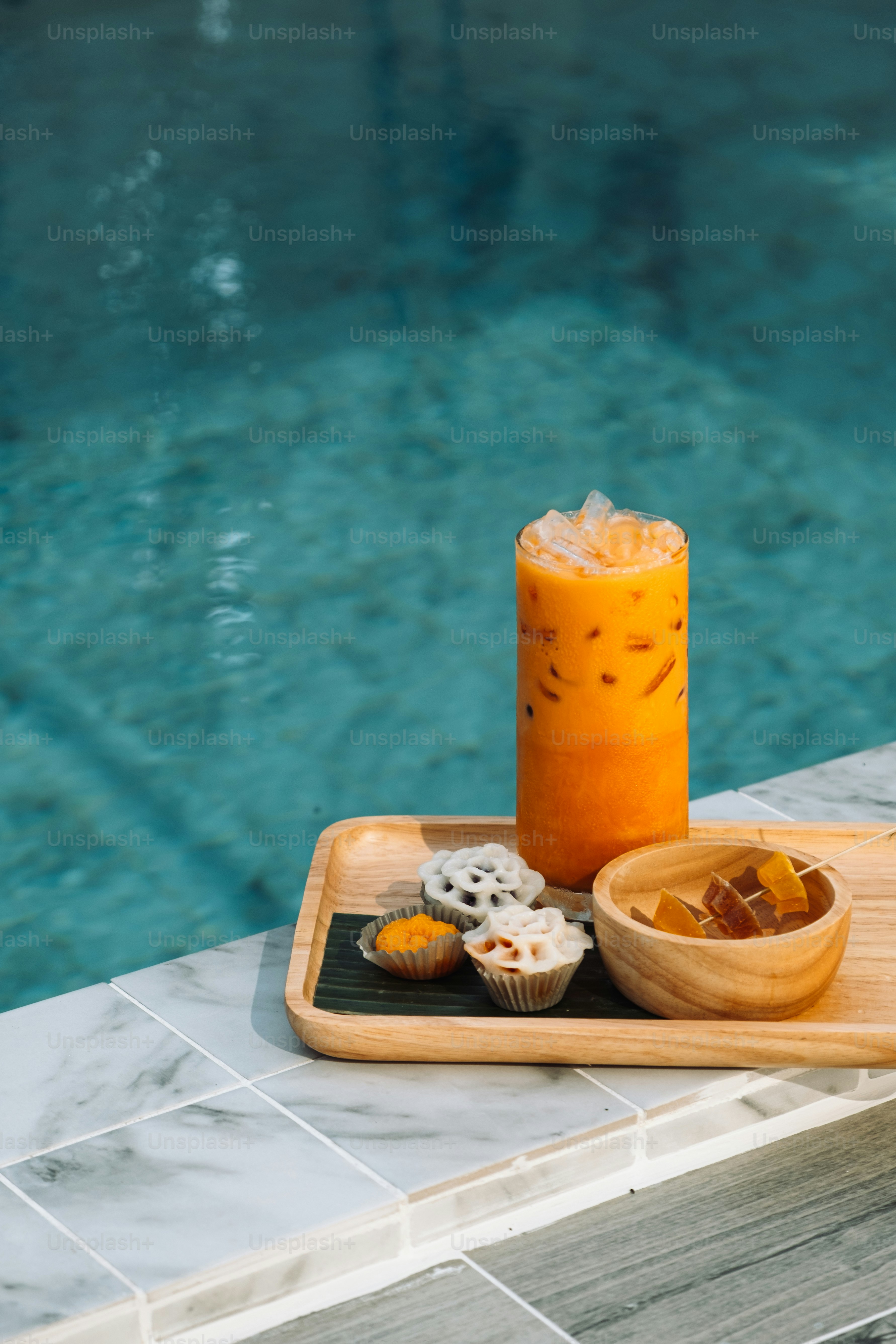 a tray of food next to a swimming pool