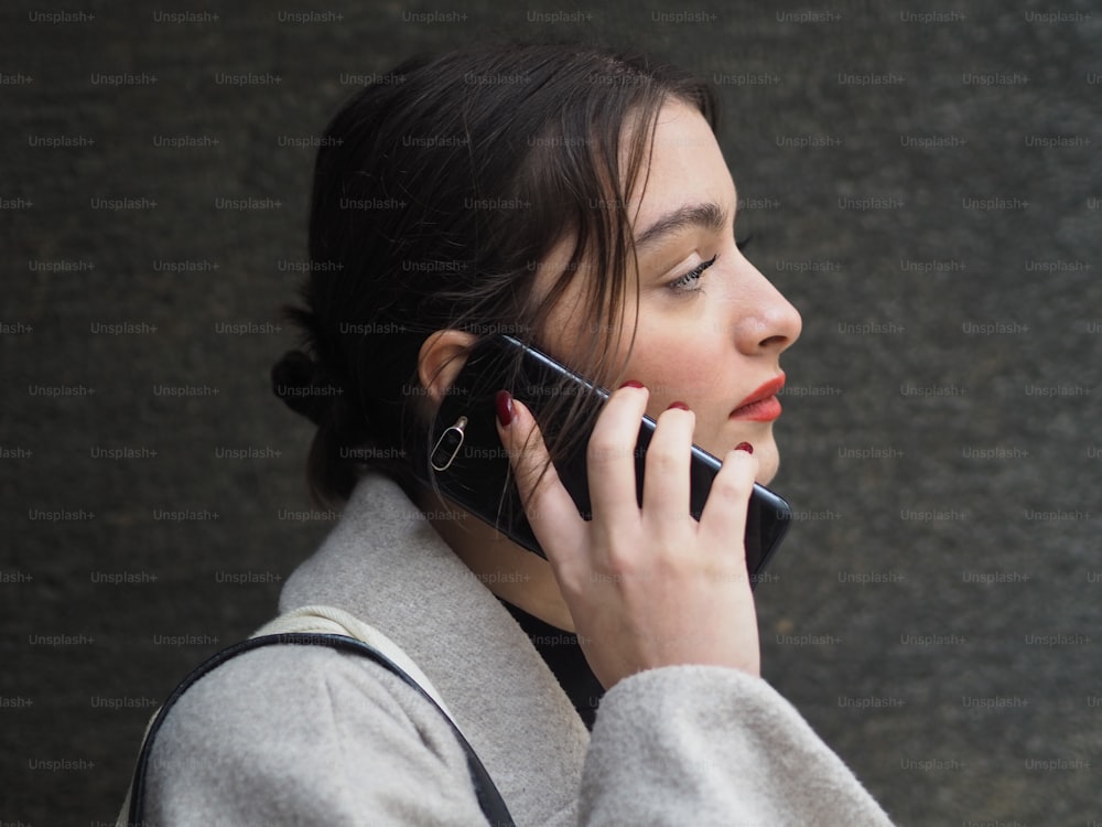 a woman is talking on a cell phone