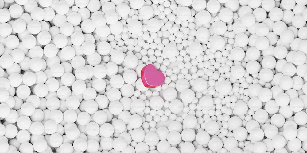 Un oggetto a forma di cuore circondato da palline bianche