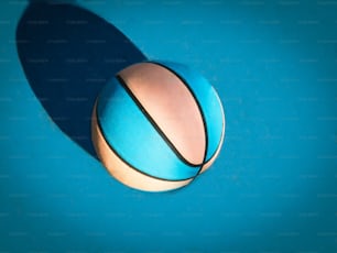 a blue and white ball on a blue surface