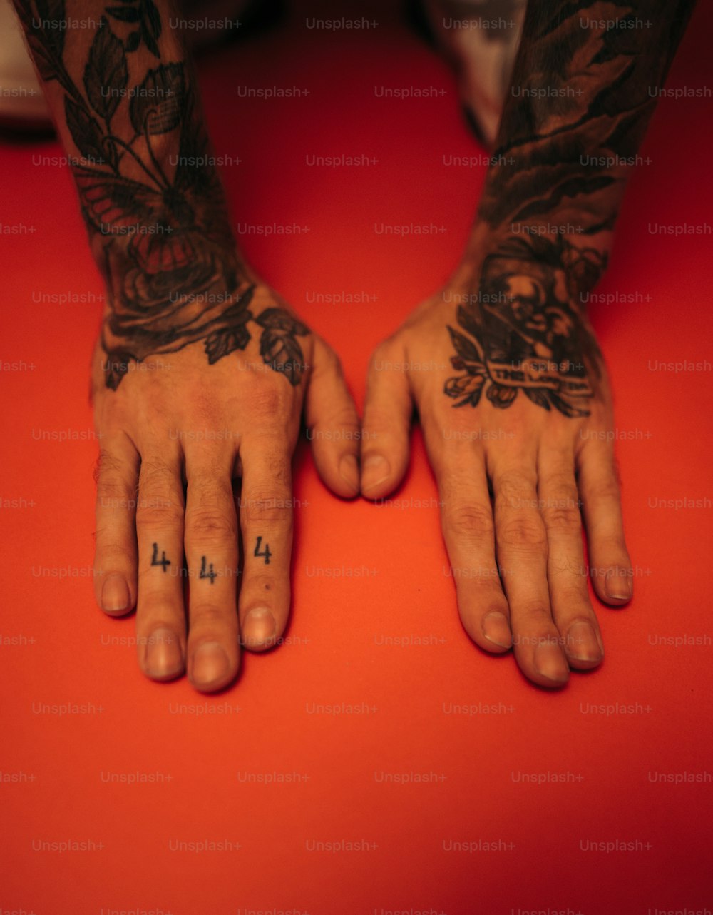una persona con tatuaggi sulle braccia e sulle mani