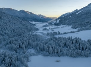 an aerial view of a snowy mountain valley