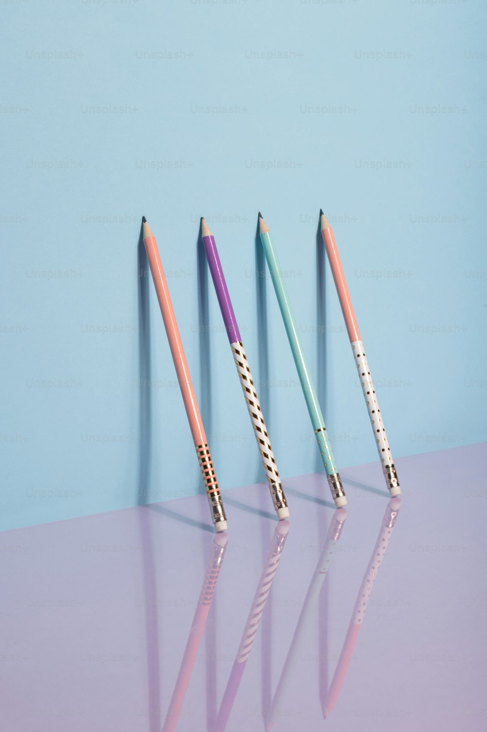 three different colored pencils are lined up in a row