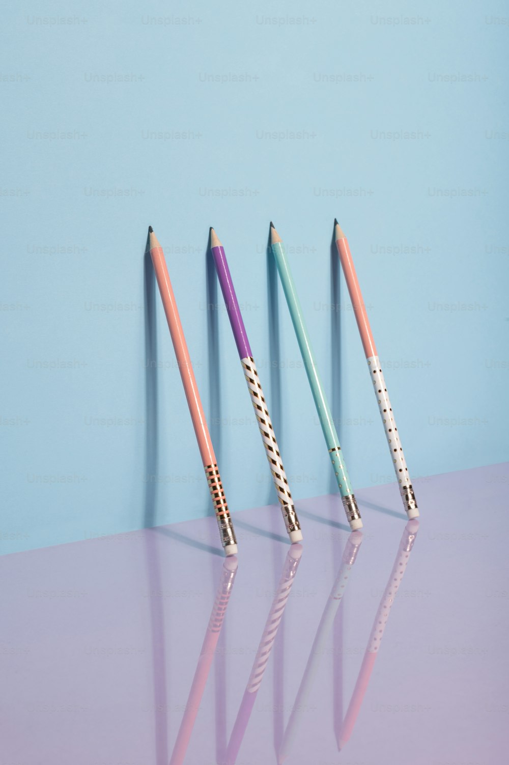 three different colored pencils are lined up in a row