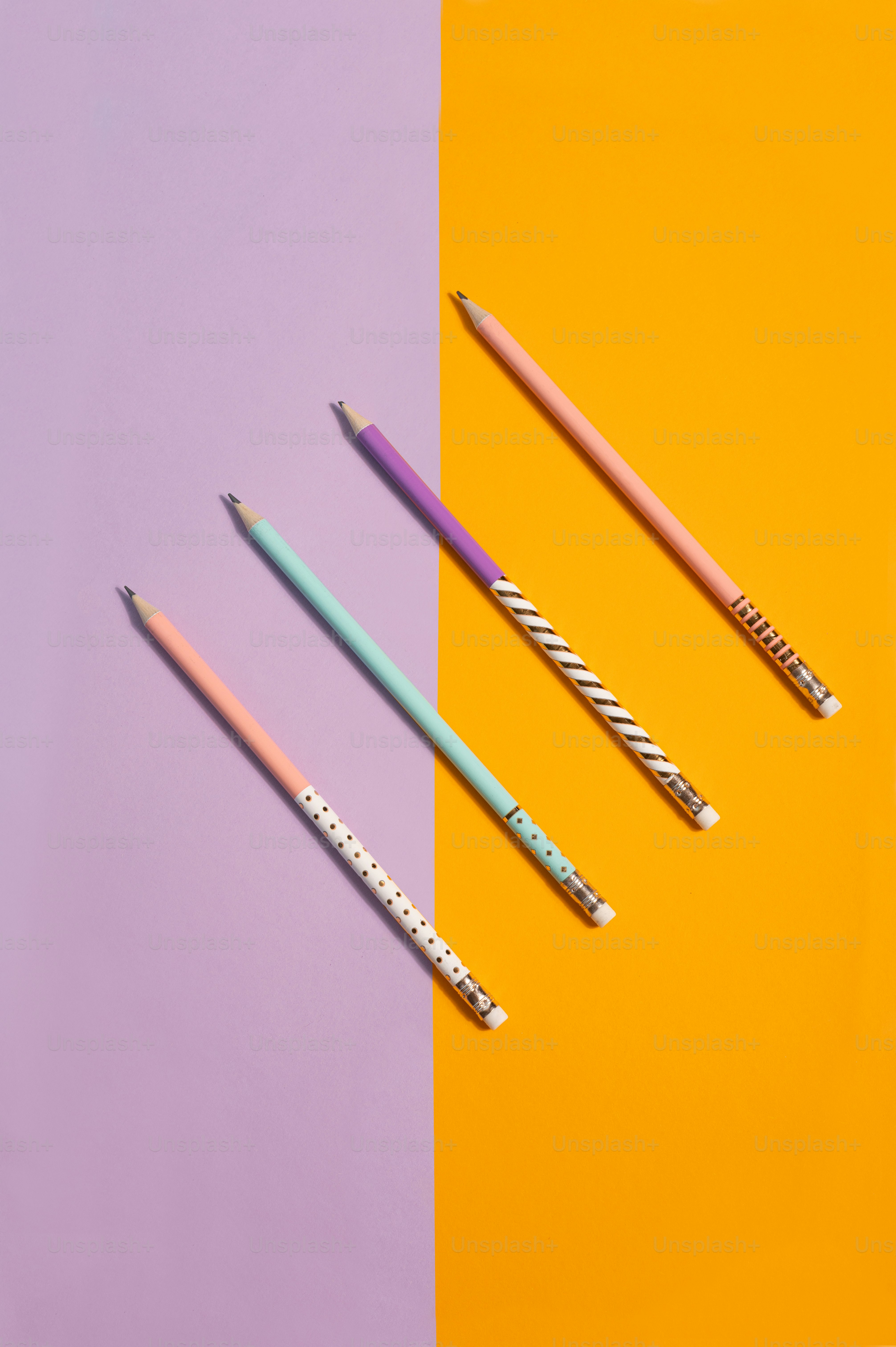 three different colored pencils sitting next to each other