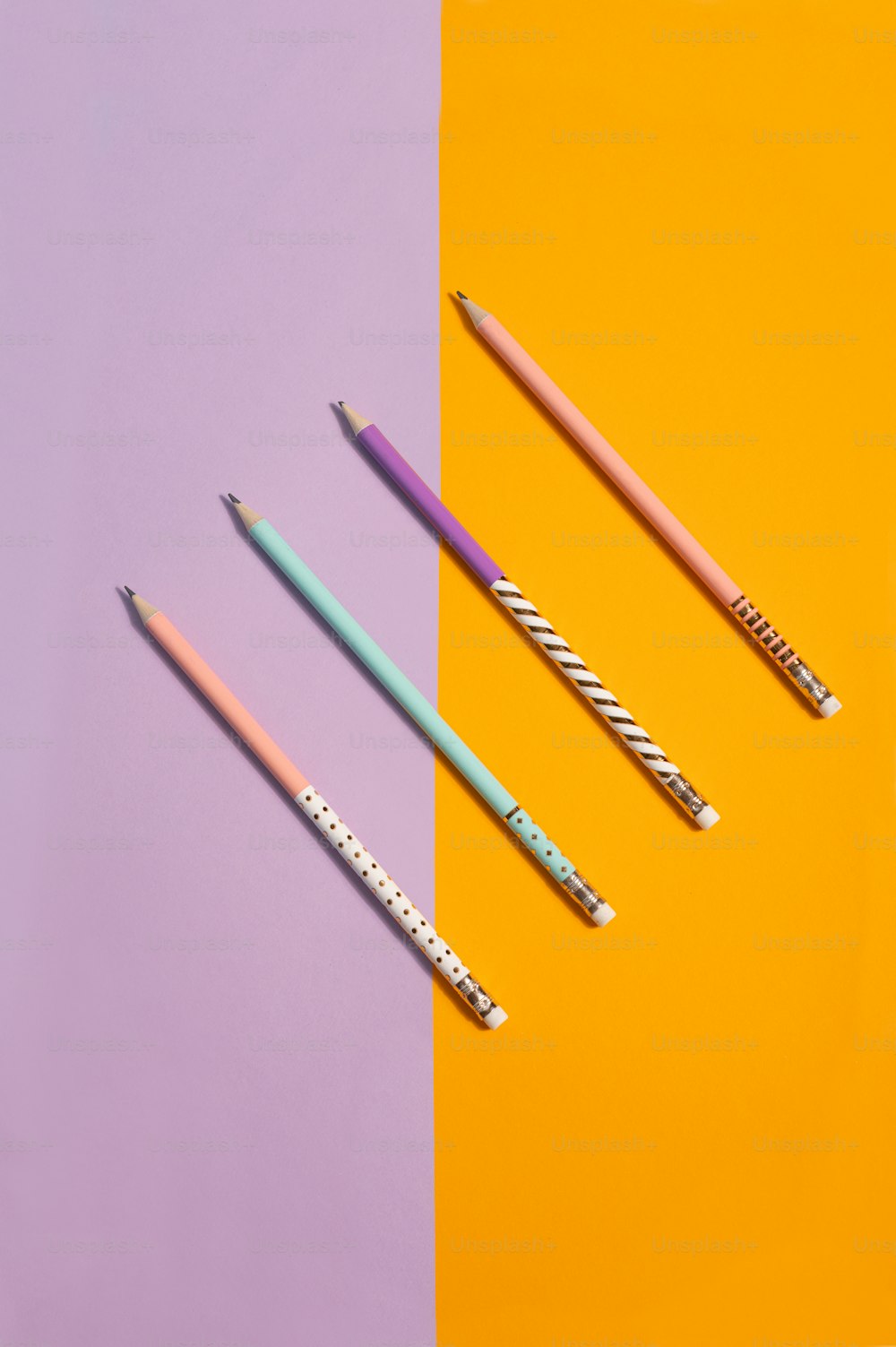 three different colored pencils sitting next to each other