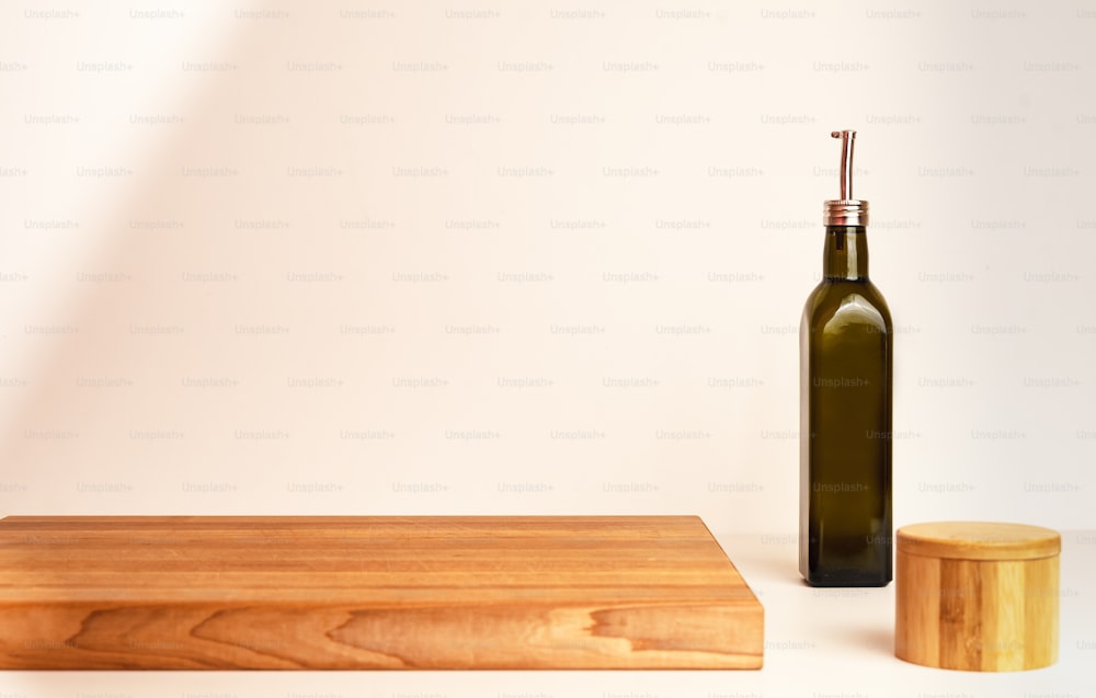 a bottle of olive oil next to a wooden block