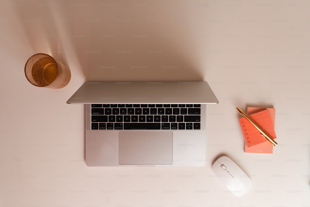 a laptop computer sitting on top of a white desk