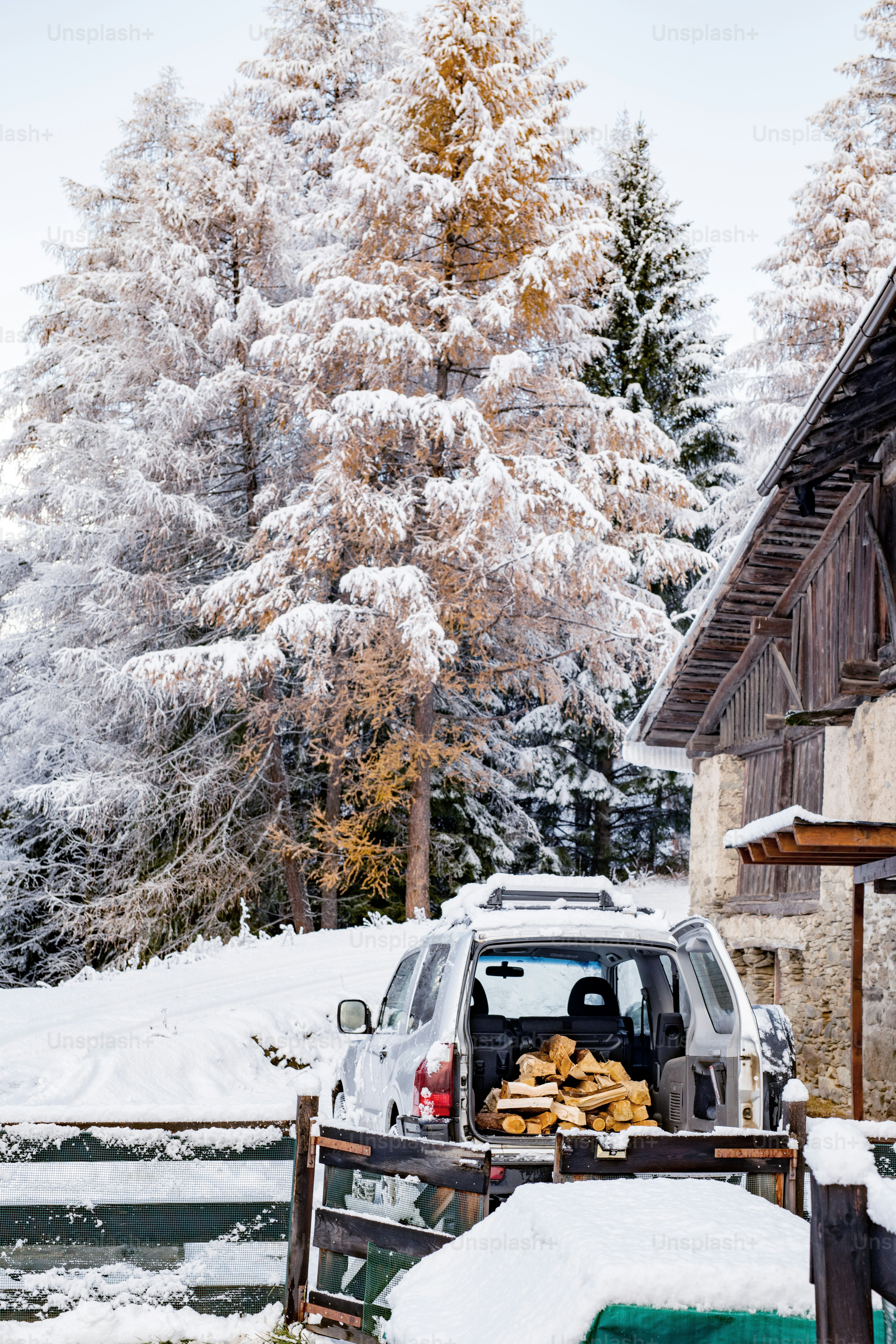 a car with a load of logs in the back of it