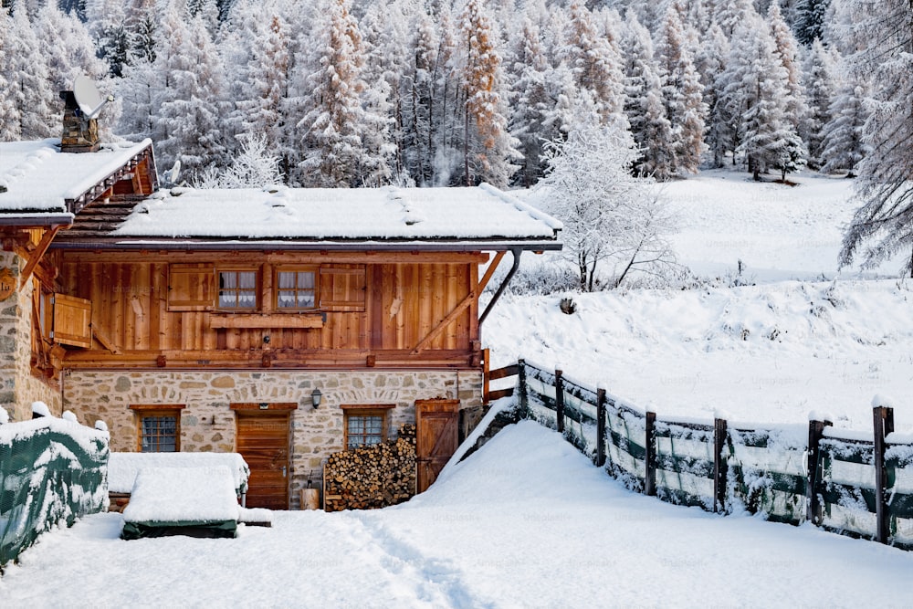 uma casa no meio de uma floresta nevada