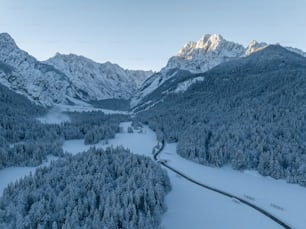 an aerial view of a snowy mountain valley
