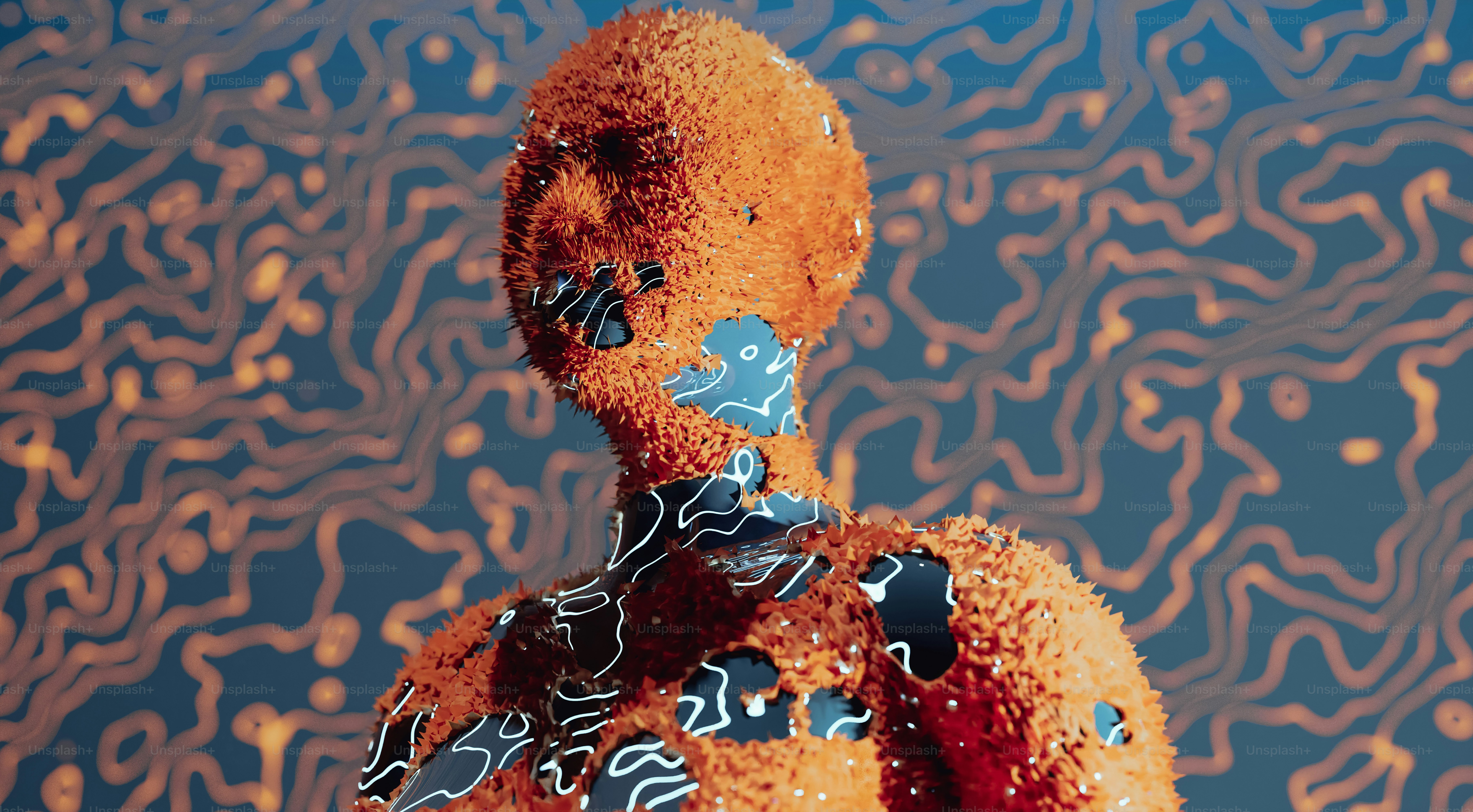 an orange teddy bear with a blue and black design on it