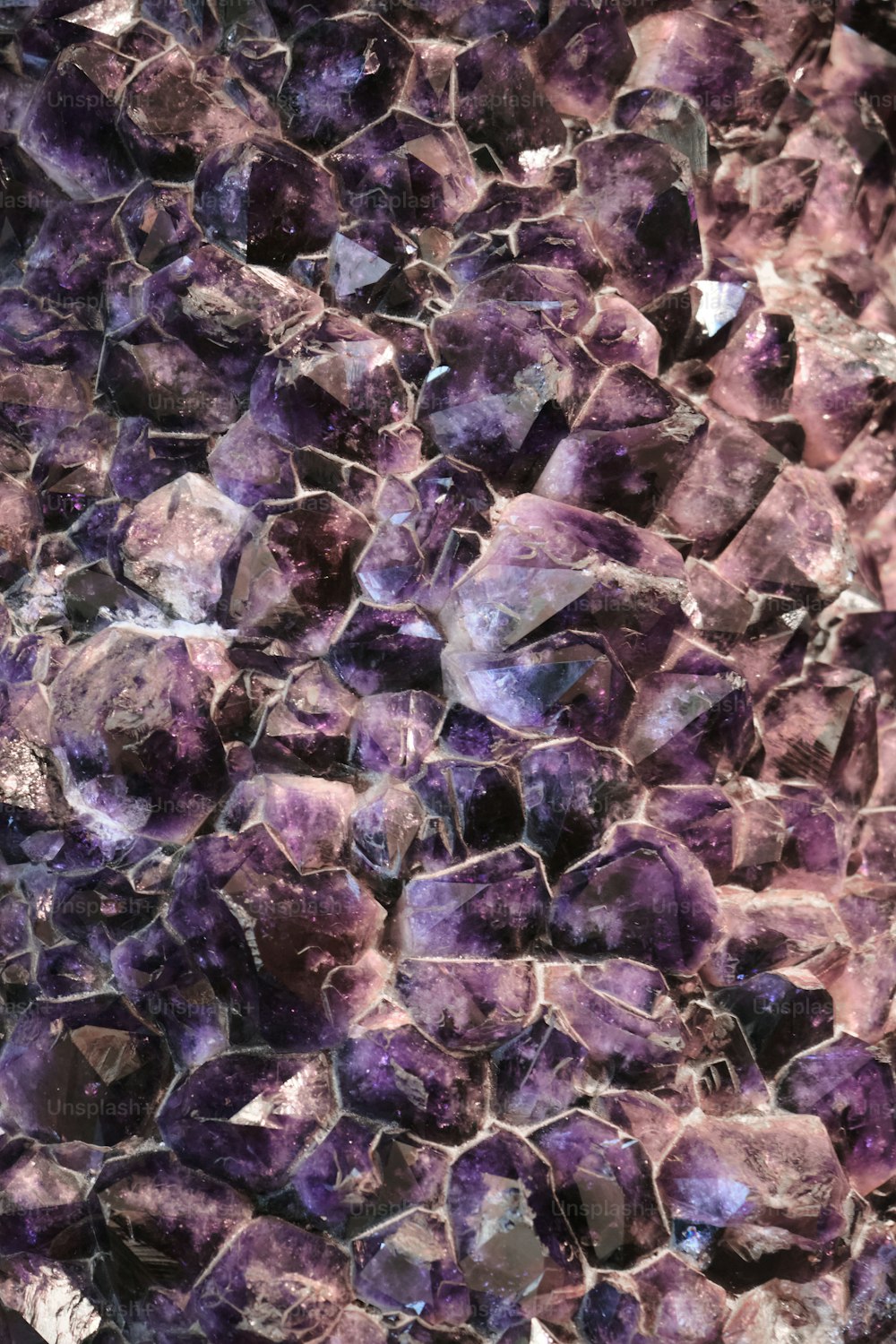 a close up of a rock with purple crystals