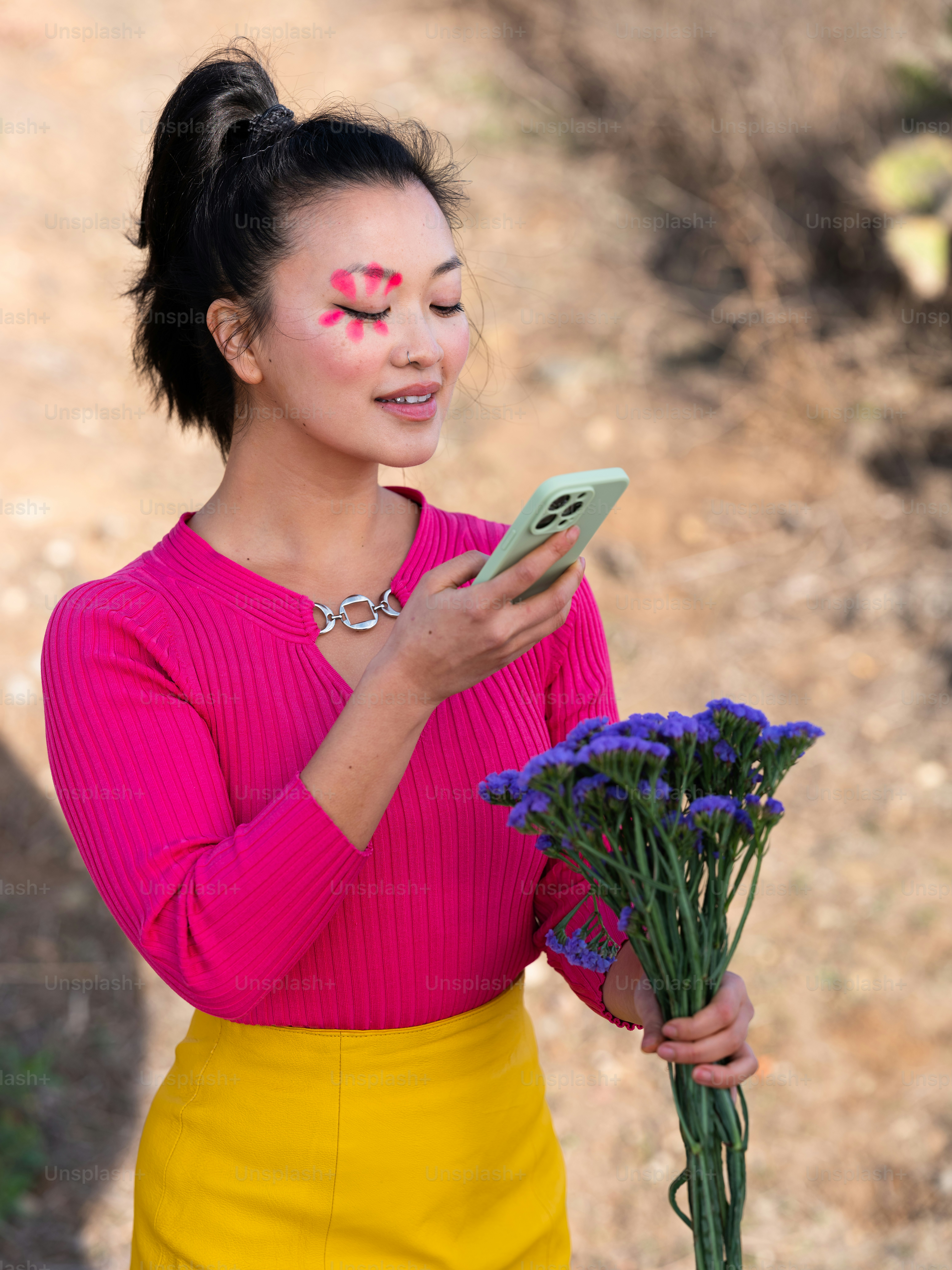 a woman holding a bouquet of flowers and a cell phone