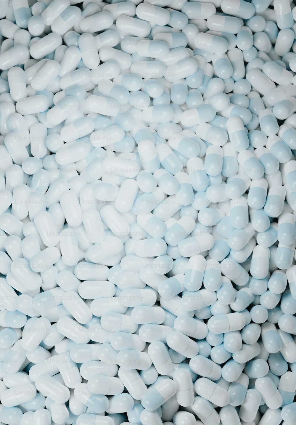 a pile of white pills sitting on top of a table