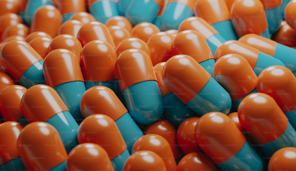 a pile of orange and blue pills sitting on top of each other