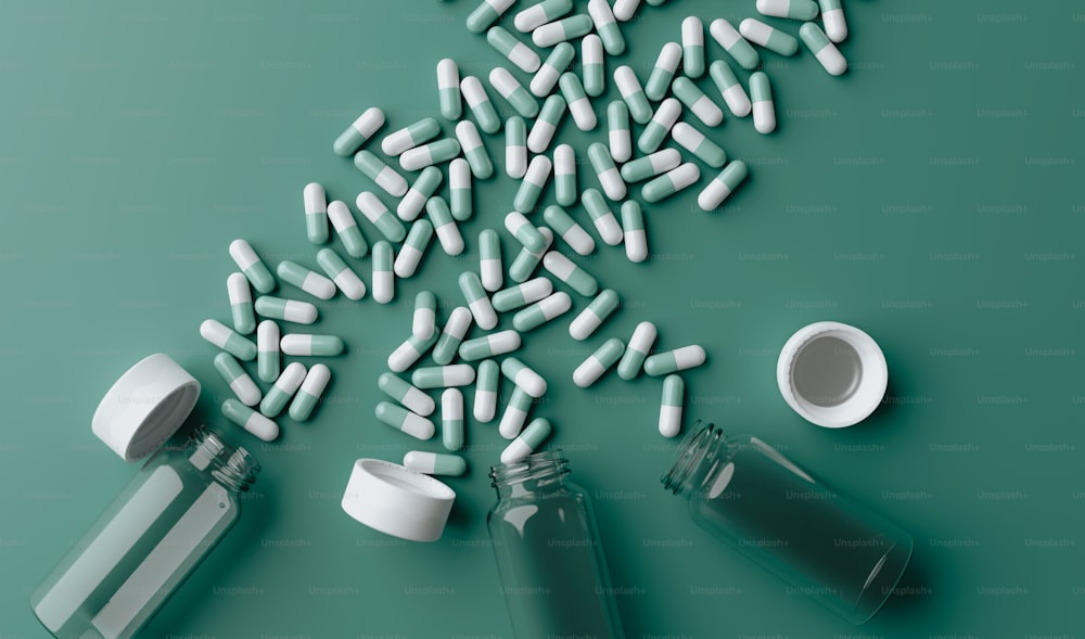 pills spilling out of a bottle onto a green surface