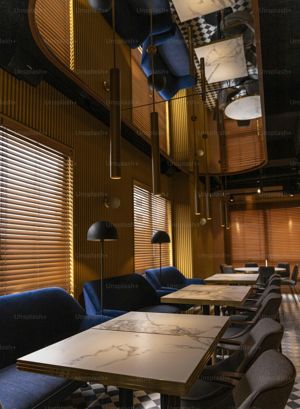 a restaurant with a long table and blue chairs