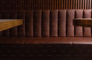 a close up of a brown leather bench